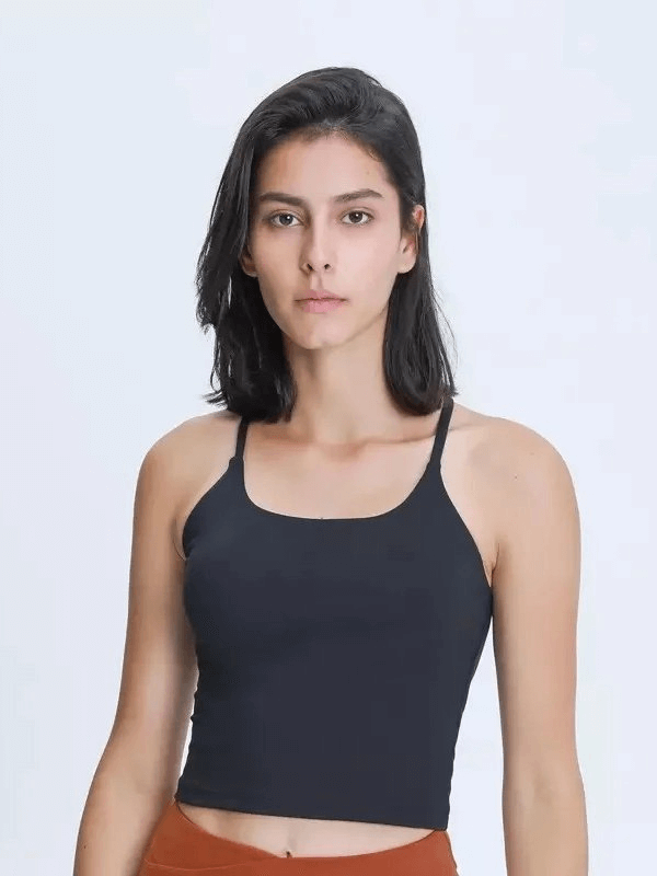 Woman wearing a black sports elastic breathable tank top with adjustable straps, ideal for fitness activities.